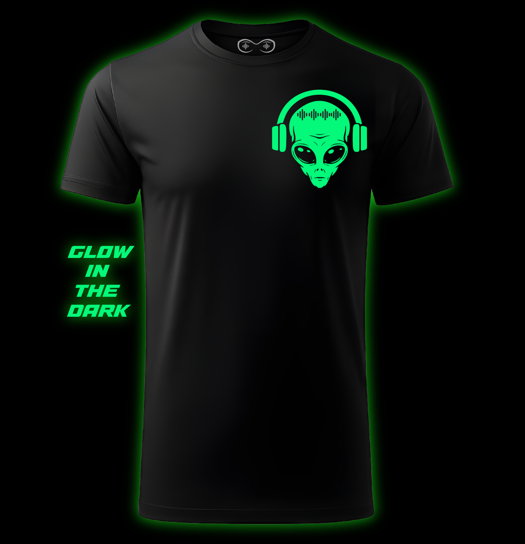 Black t-shirt with a glowing green alien design on a black background